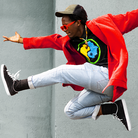 leaping man in red jacket and sunglasses