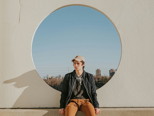 man sitting in front of circular frame