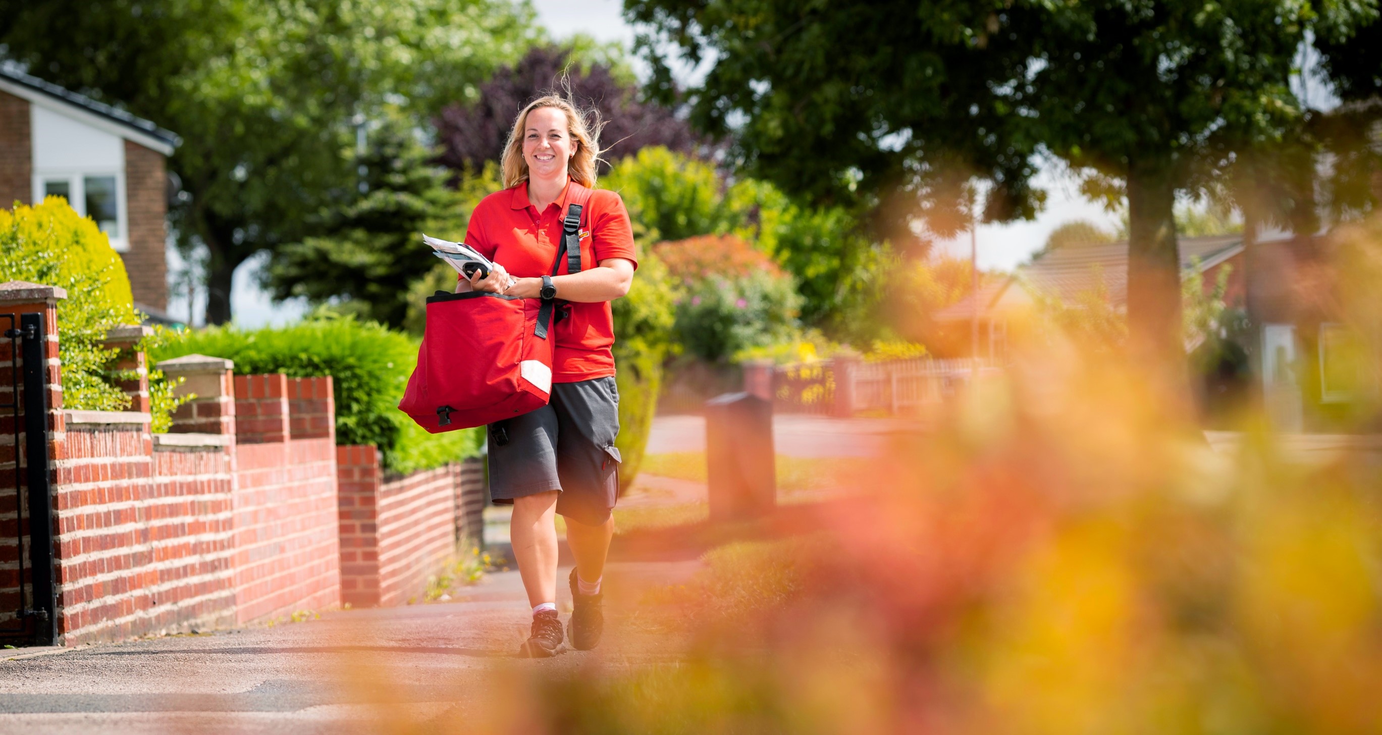 Royal Mail post person delivering mail