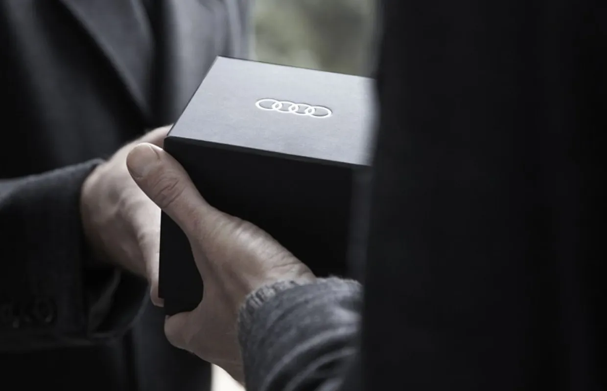Black Audi box in someones hand