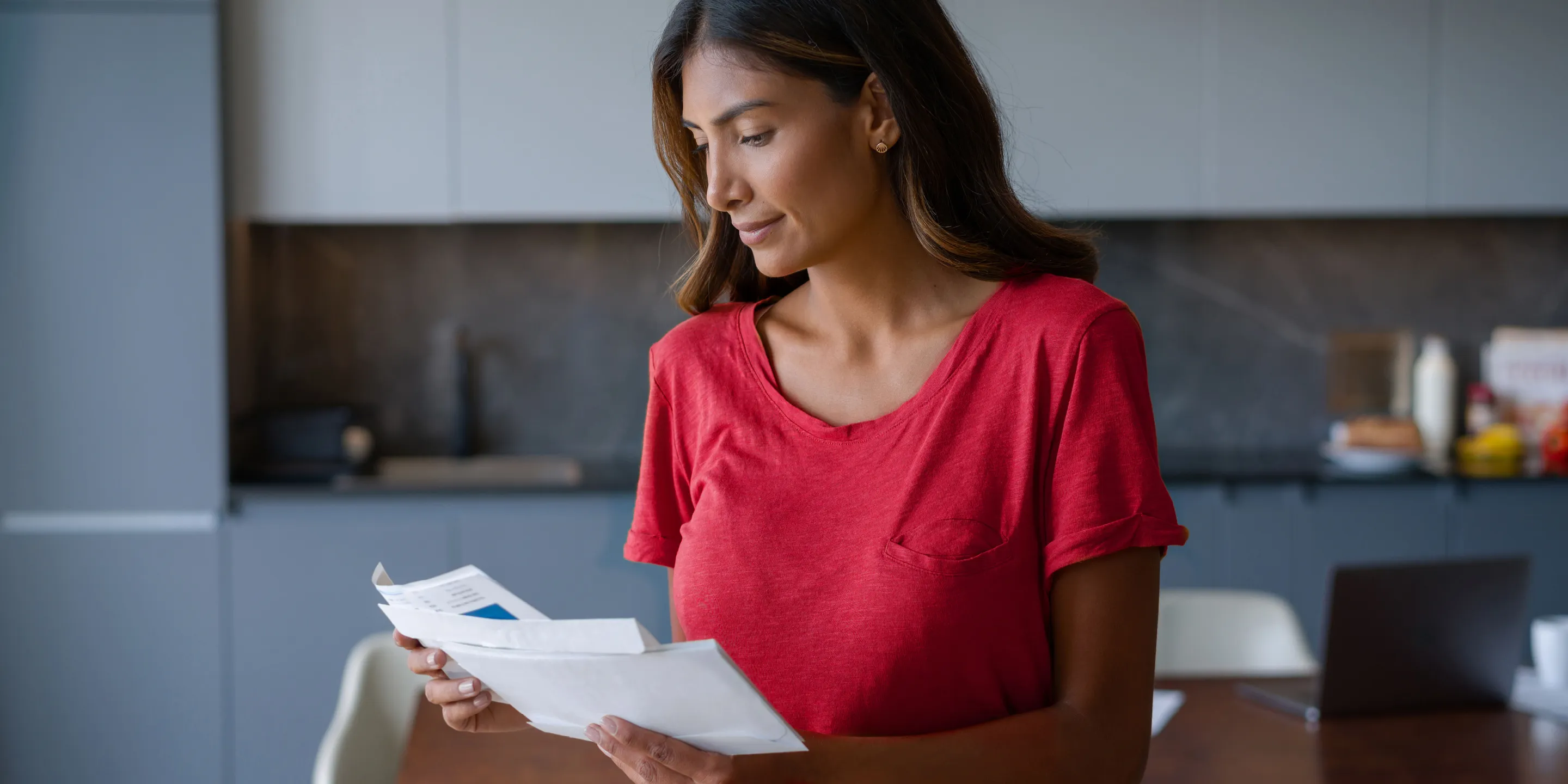 a woman reading a letter