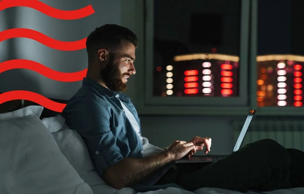 Man sitting at laptop in the dark